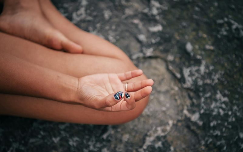 Close up of hands in a meditative mudra position during practice.